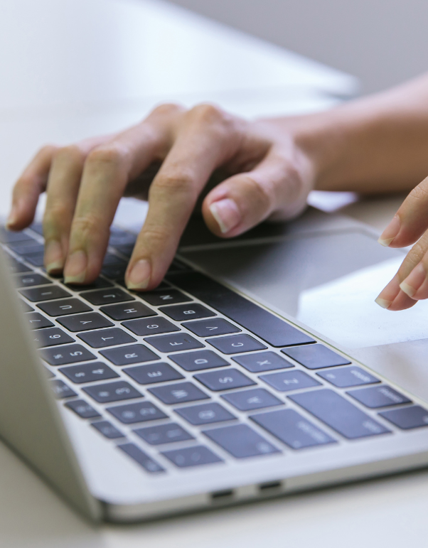 A close up of a person typing on a laptop