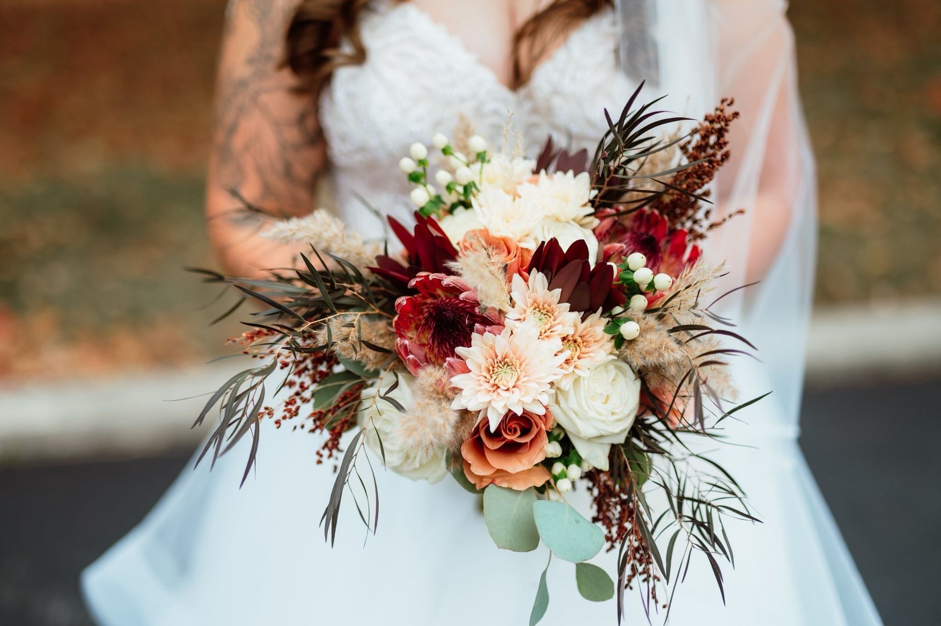 Close-up of a floral table setting with white peonies, succulents, and glassware. Close-up of a floral table setting with white peonies, succulents, and glassware.