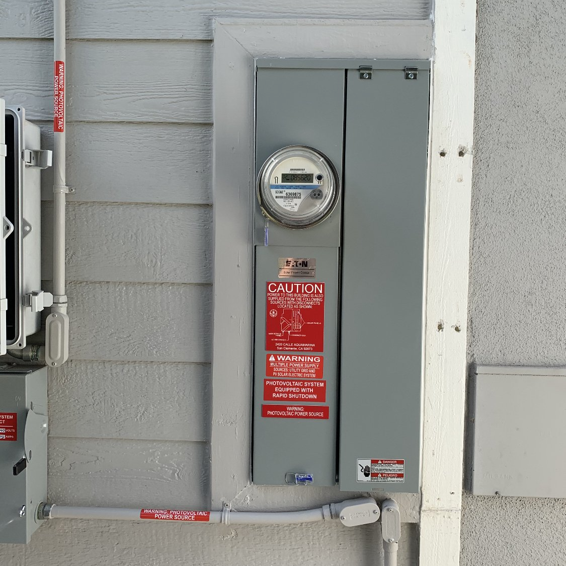 An upgraded electrical panel on the outside of a house