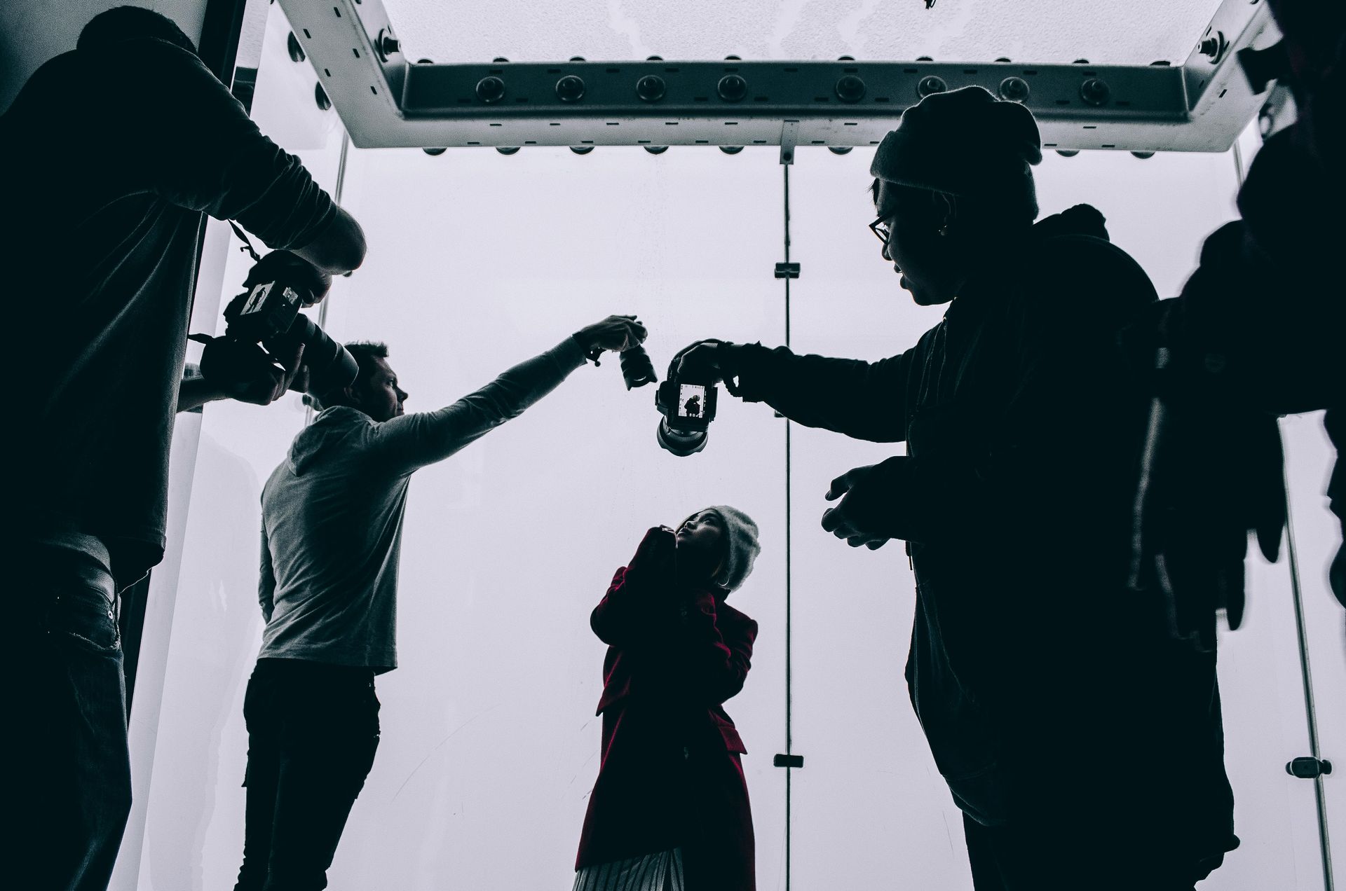 A group of people are standing in a room holding hands.