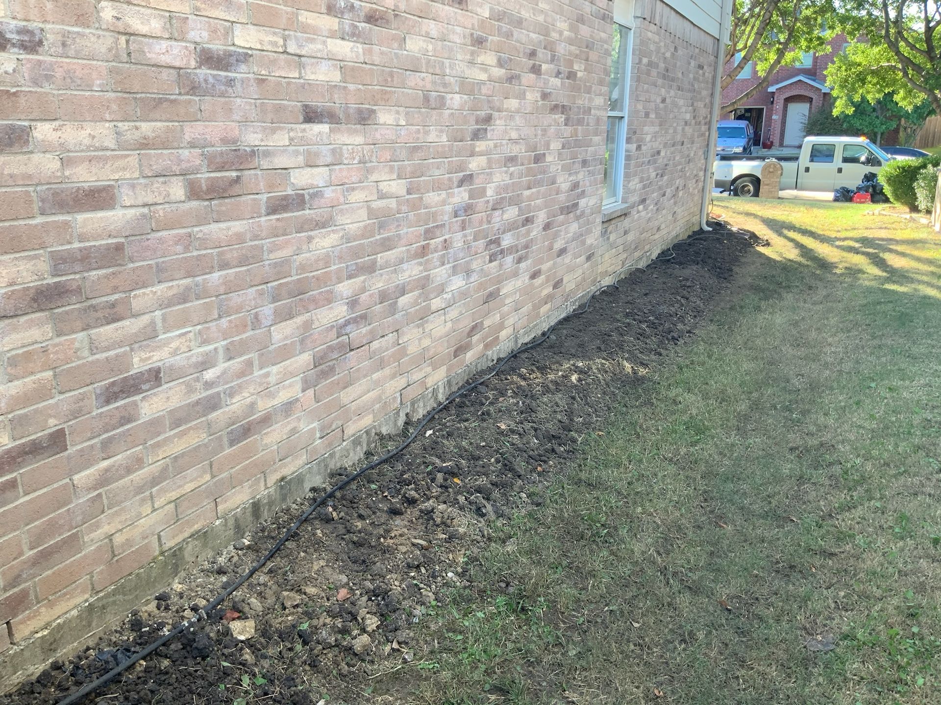 a brick house with a truck parked in front of it