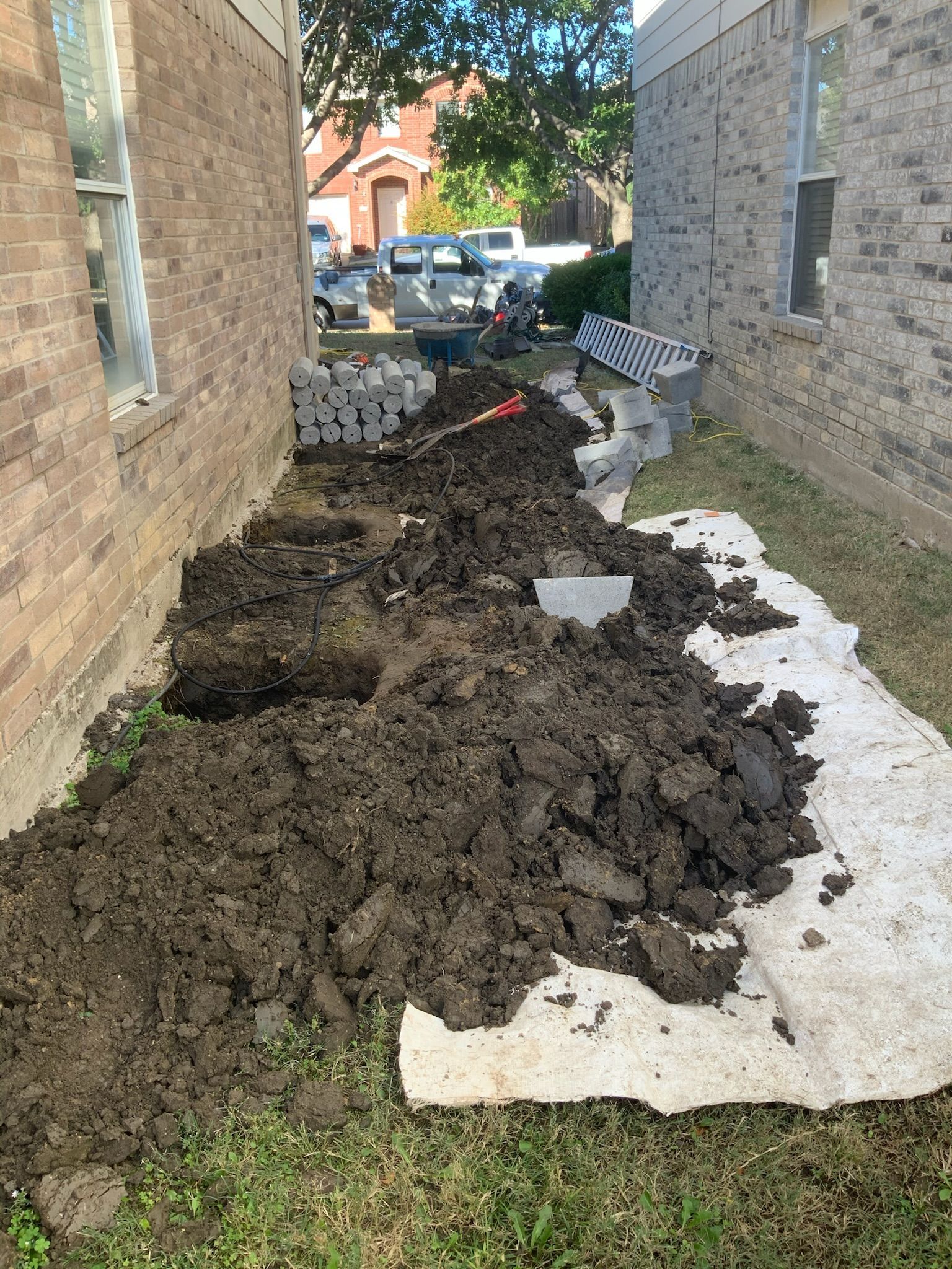 a pile of dirt is sitting in front of a brick building