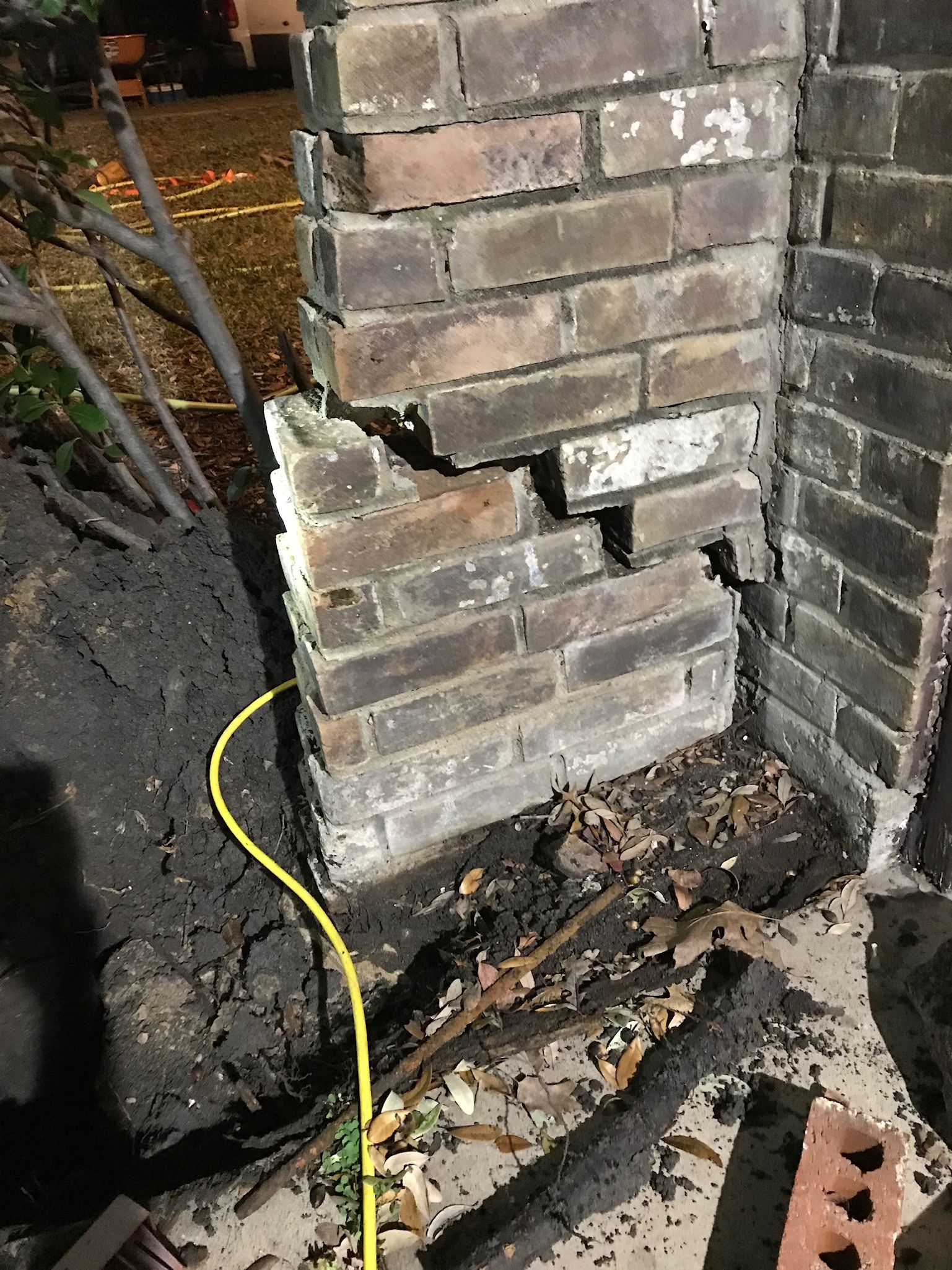 a yellow cord is plugged into a brick wall