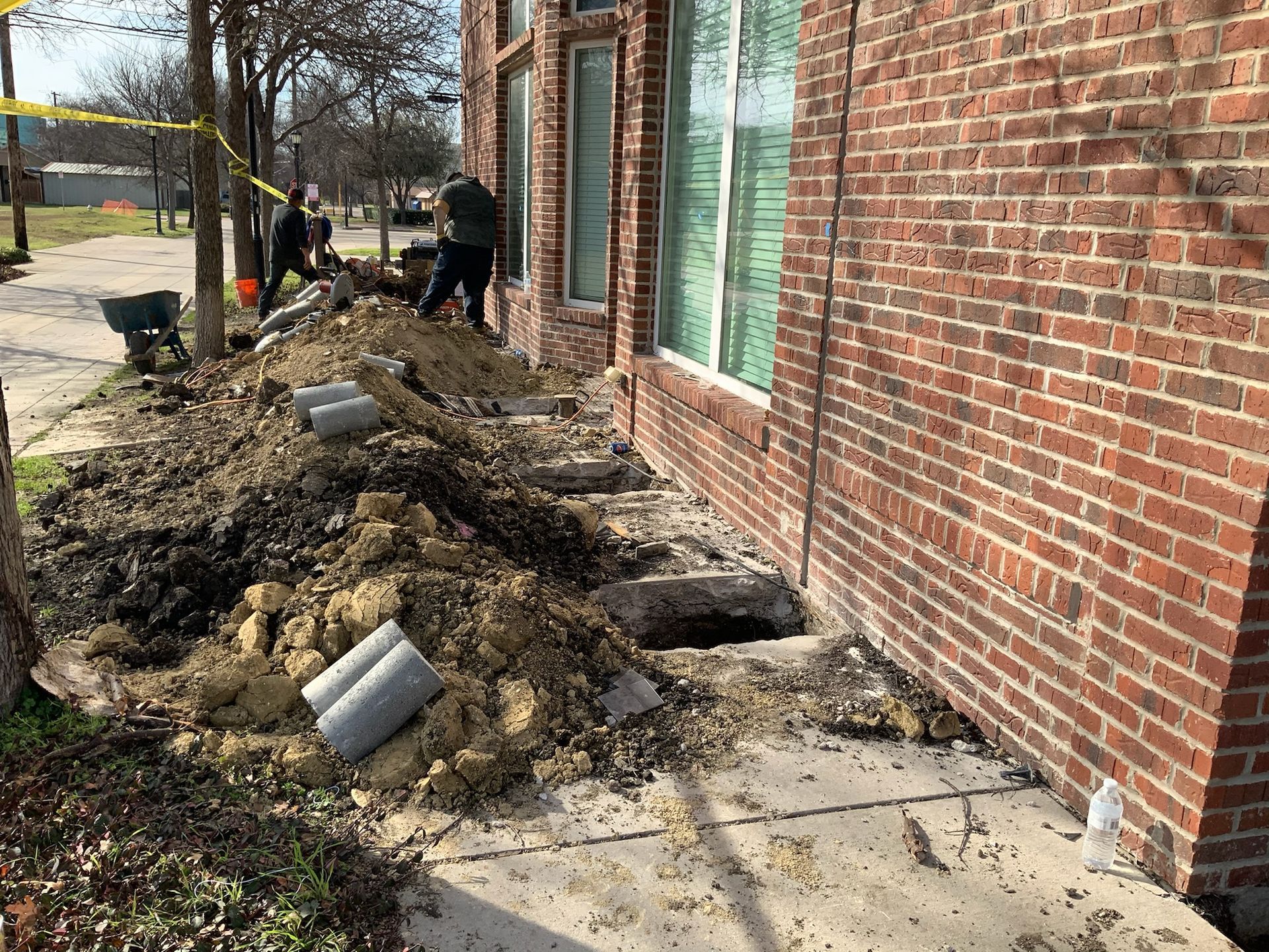 a brick building with a pile of dirt in front of it