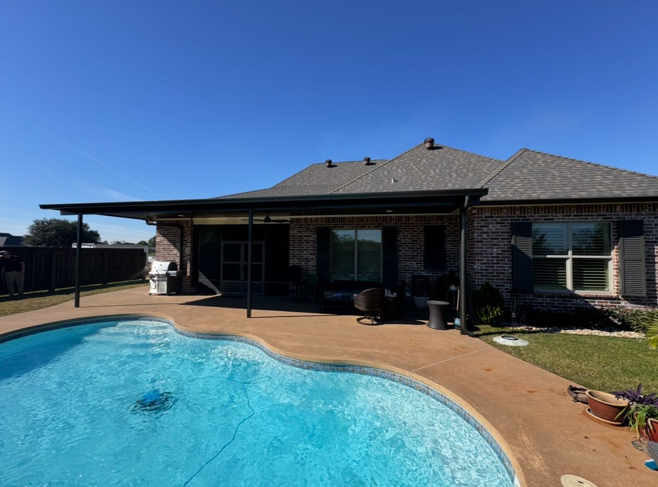A house with a swimming pool in front of it.