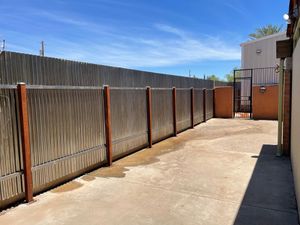 A wooden fence along the side of a building