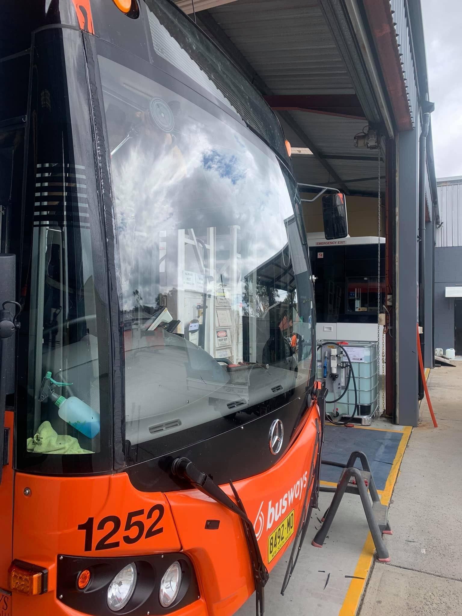 Orange Parked Bus Parked at Maintenance Garage