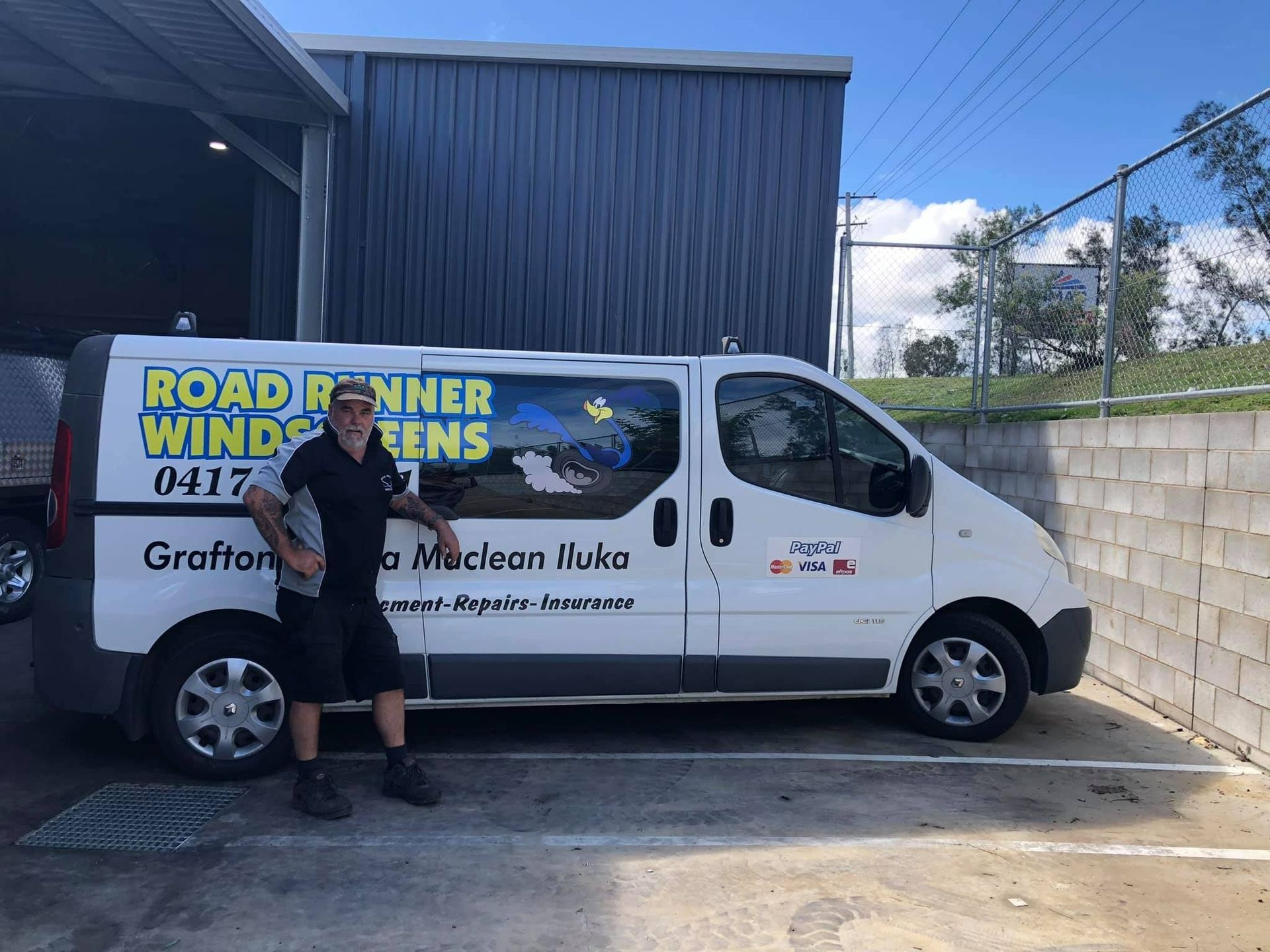 Man Stands Next to a White Van — Road Runner Windscreens in South Grafton, NSW