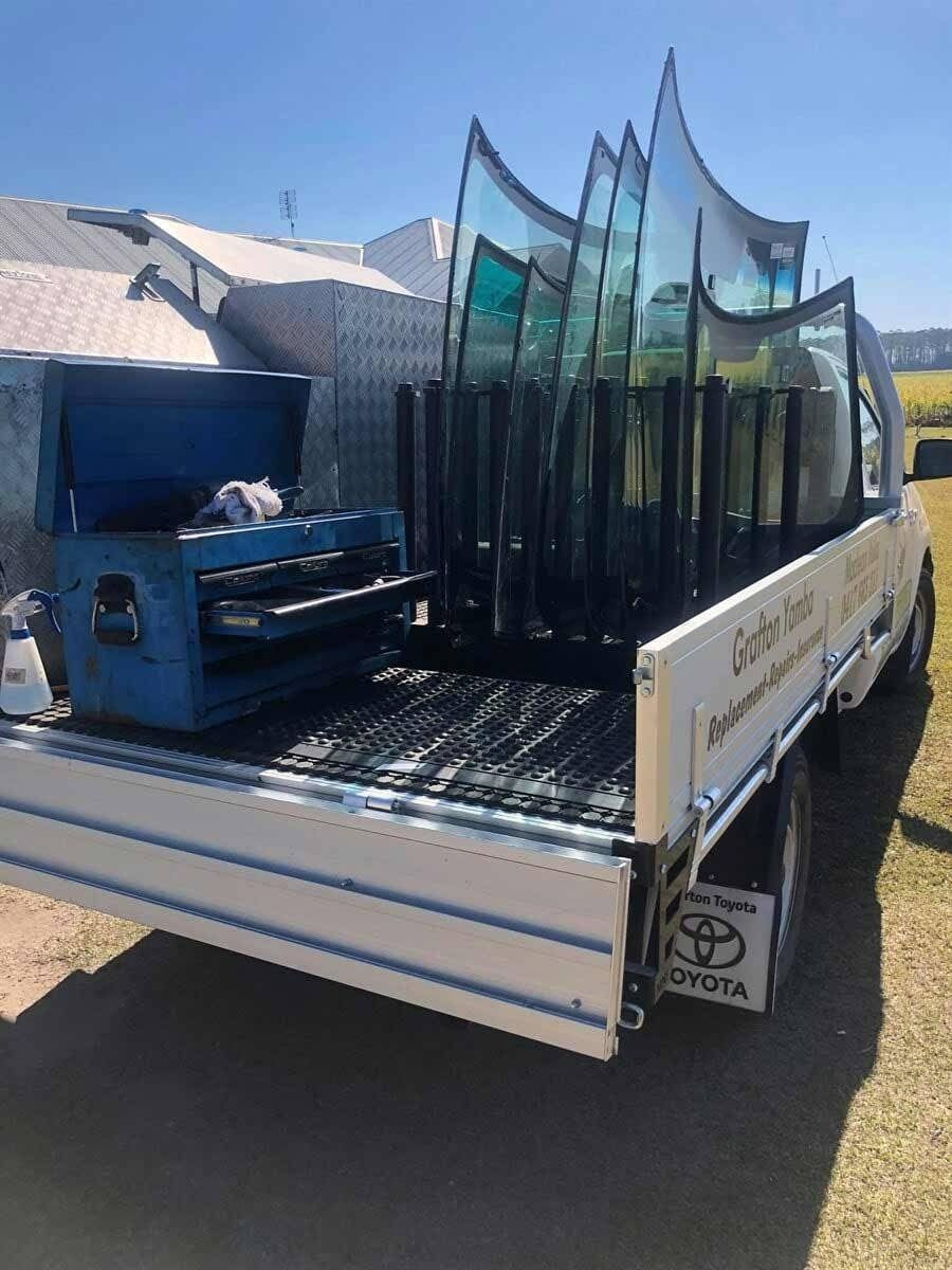 White Toyota Truck Bed Carrying Glass Panes for Installation — Road Runner Windscreens in Clarence Valley, NSW