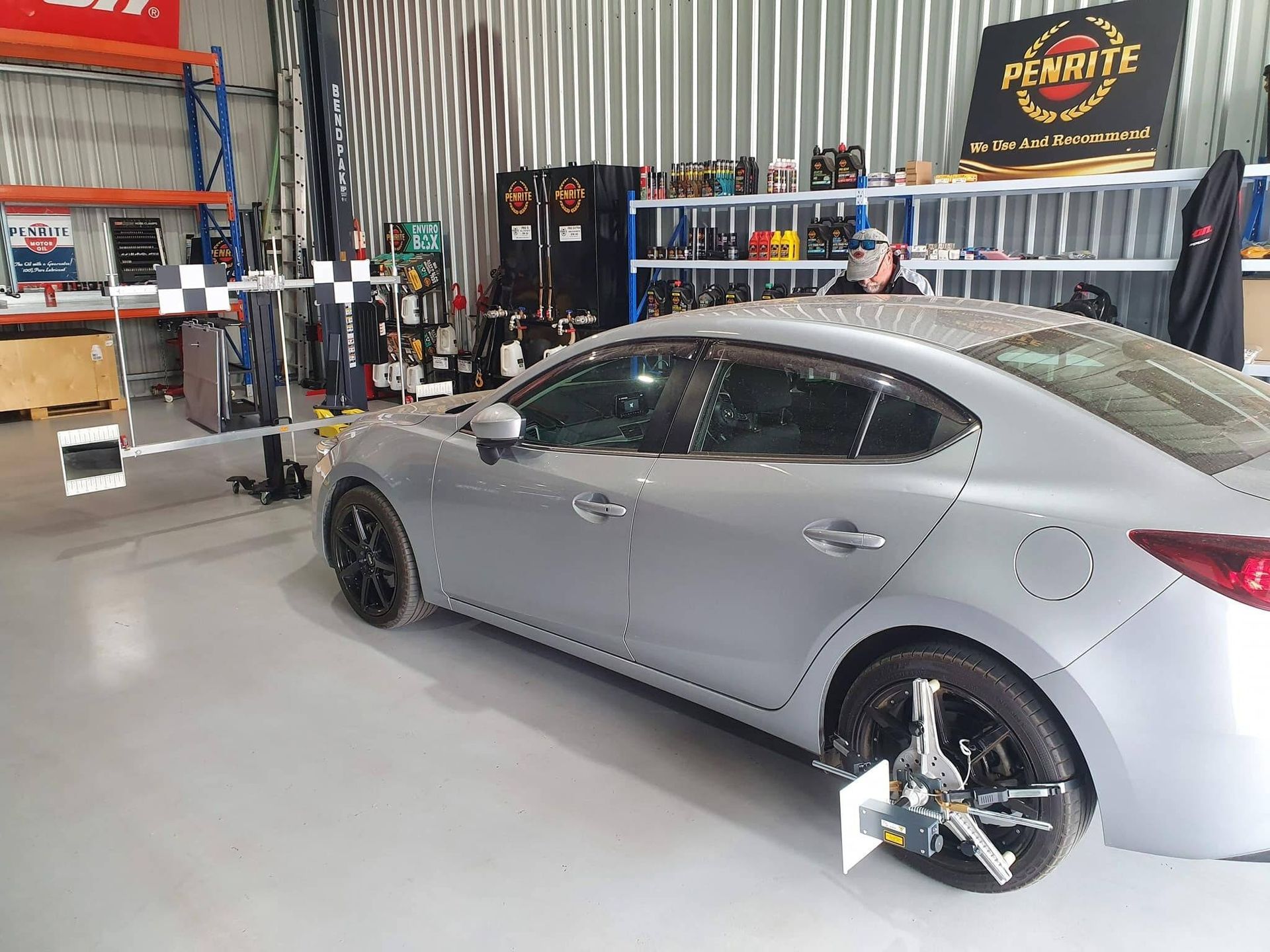 A Grey Car Undergoing Wheel Alignment in a Workshop — Road Runner Windscreens in South Grafton, NSW