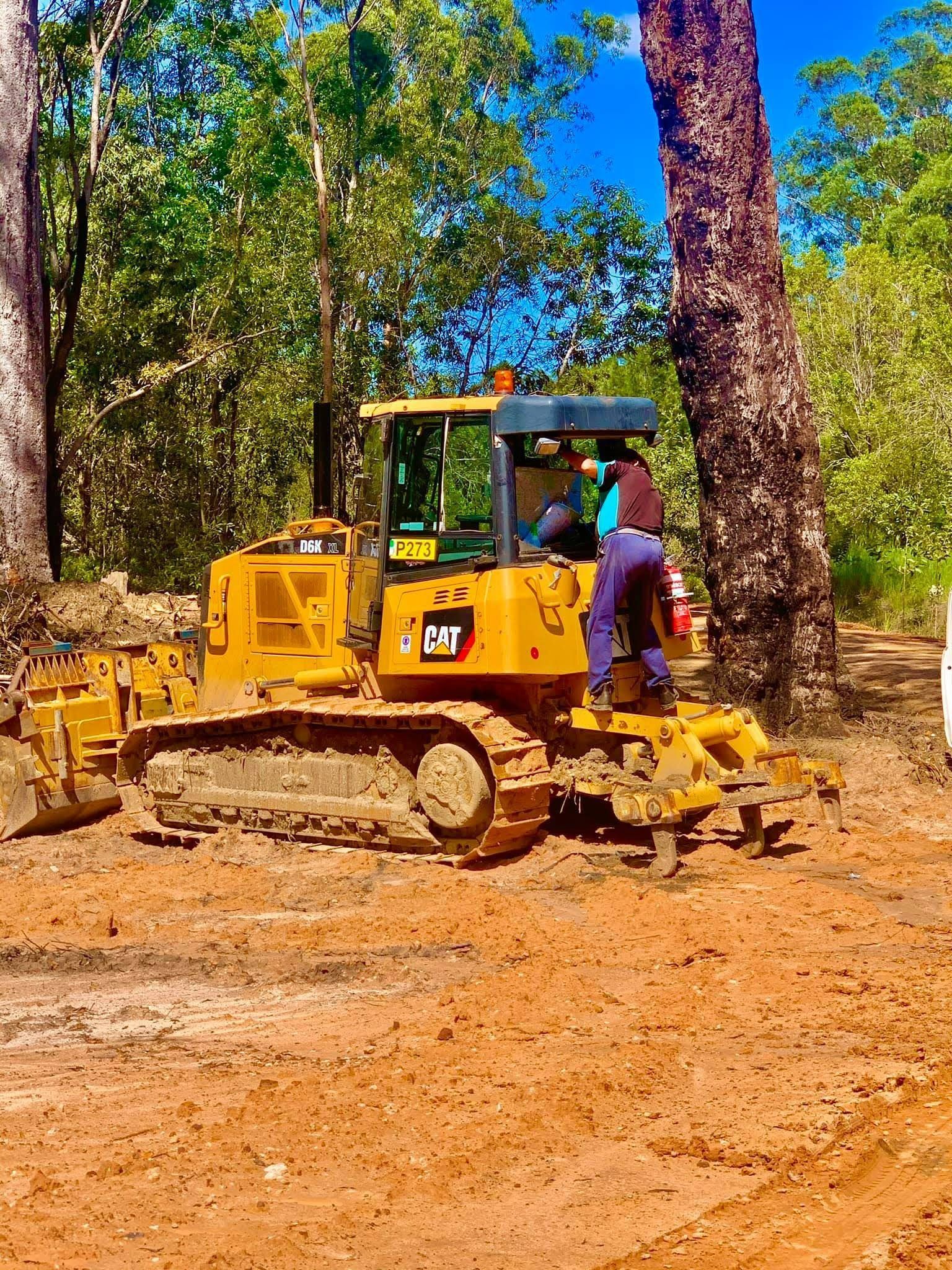 Yellow Caterpillar Bulldozer With Two People — Road Runner Windscreens in South Grafton, NSW