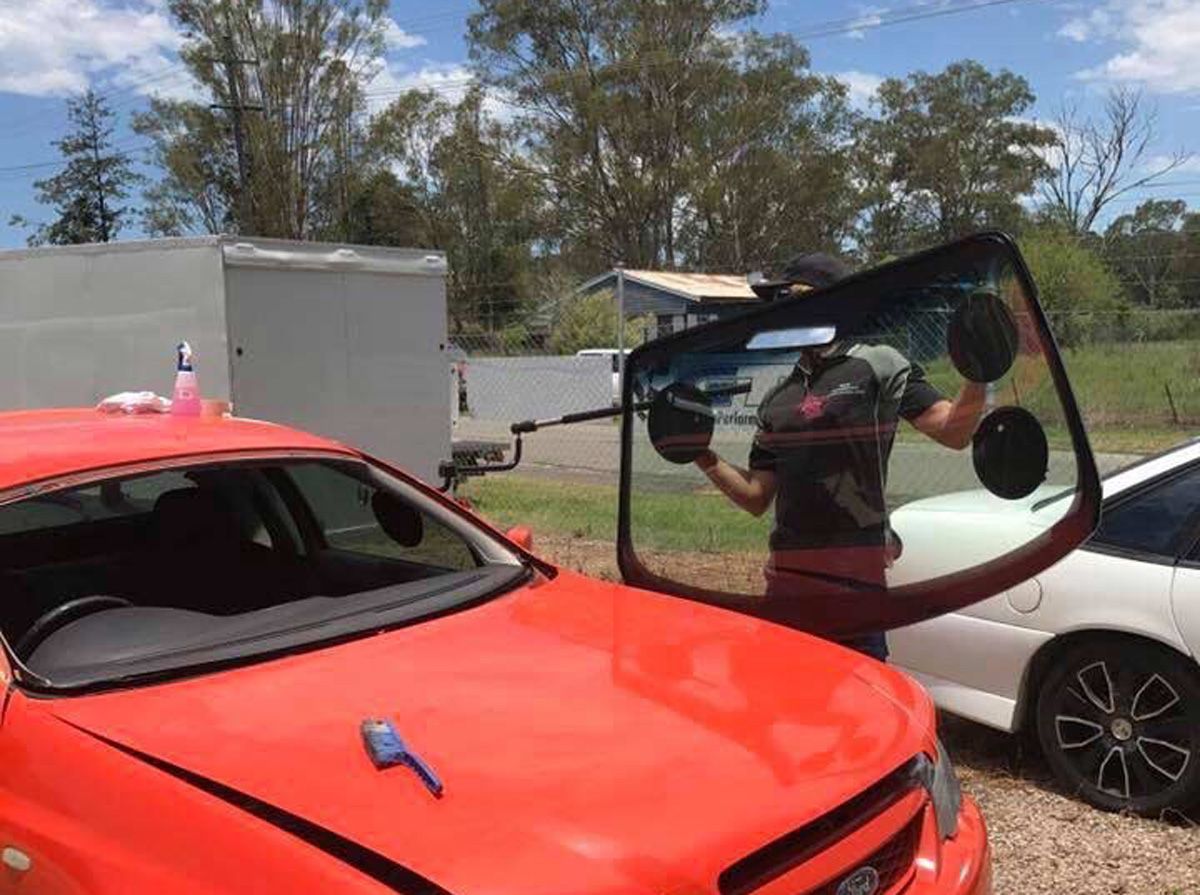 Man Working For A Windscreen Replacement In Grafton