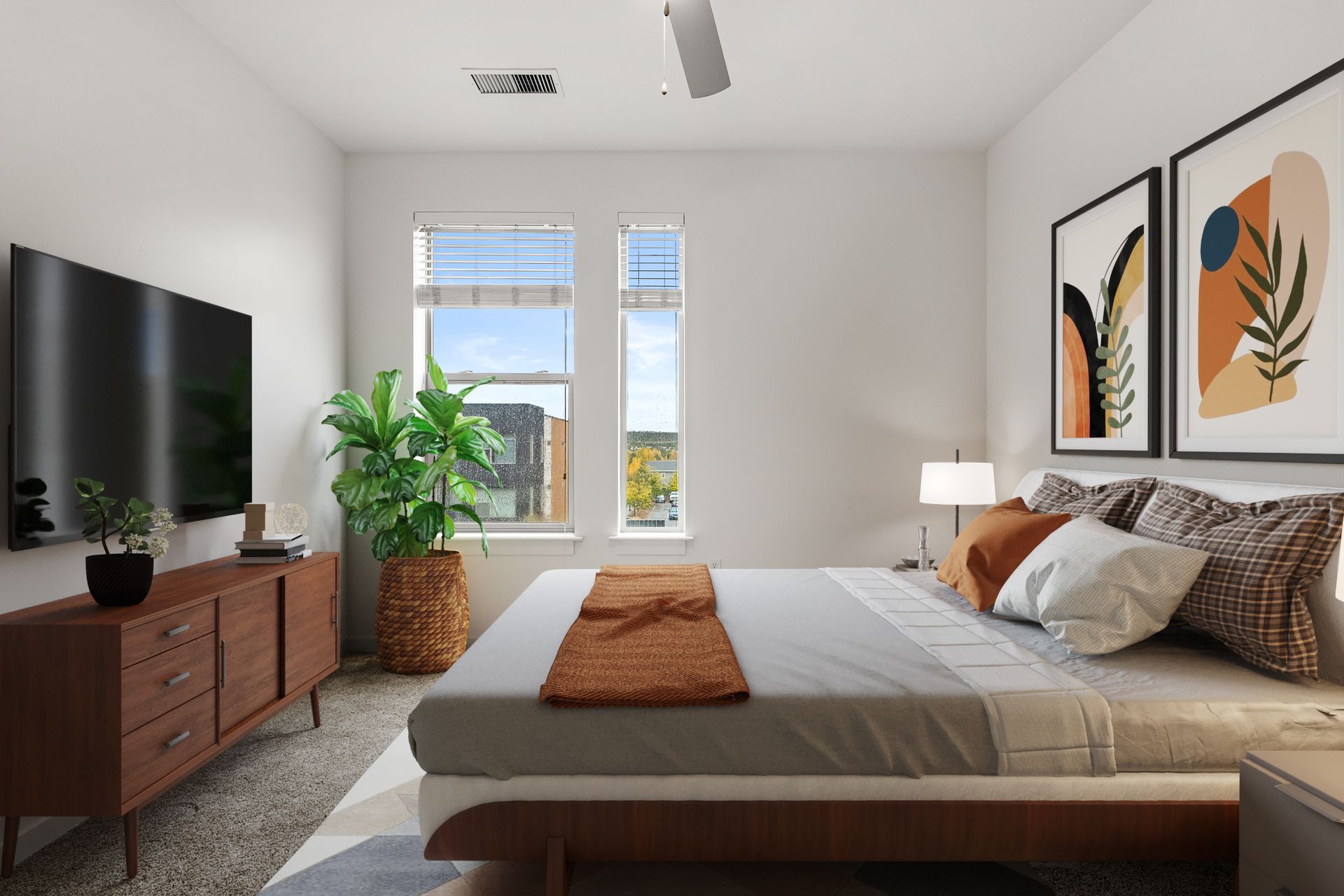 Bedroom with a queen bed, wooden dresser, potted plant, and two tall windows.