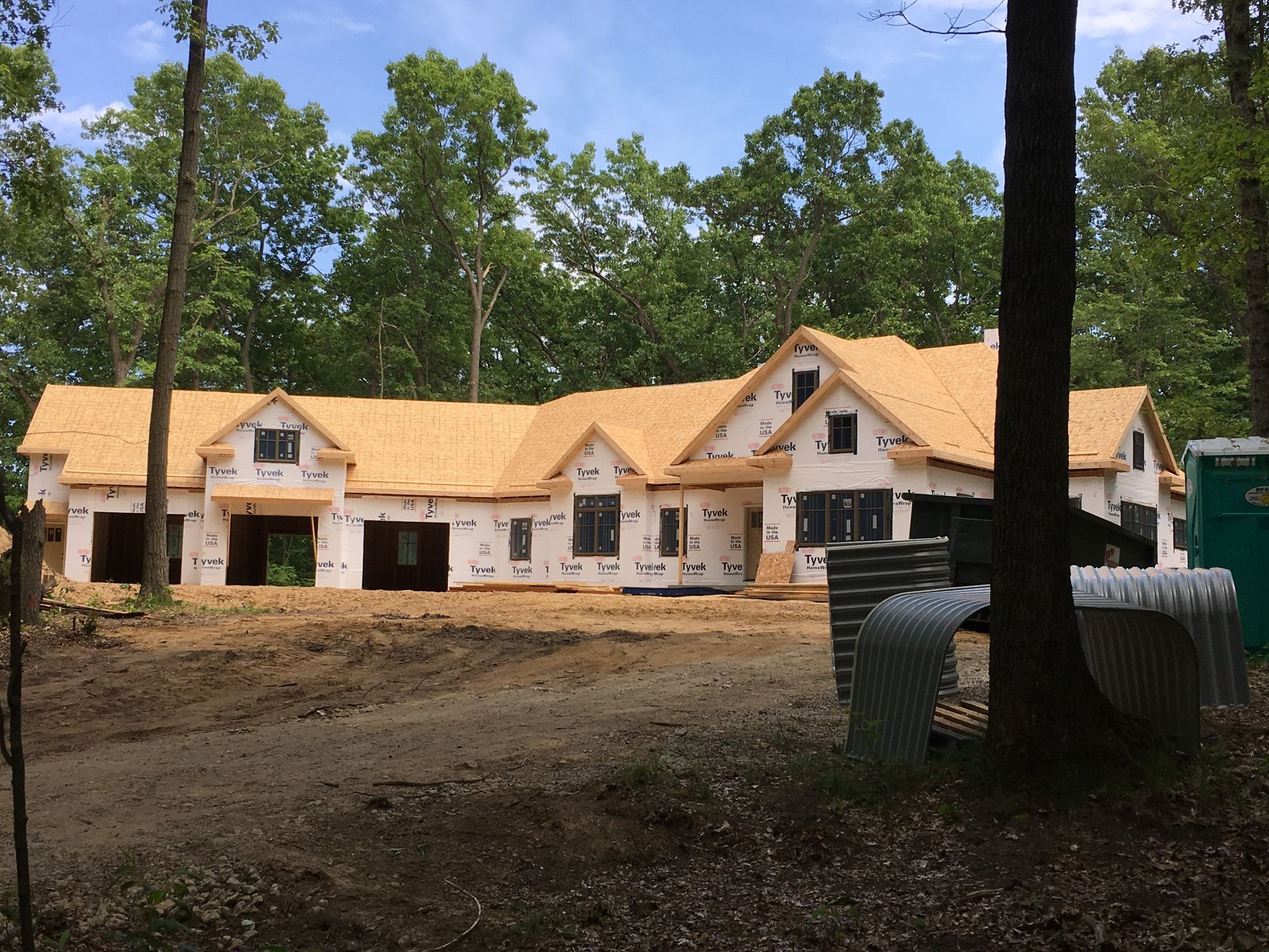 A large house is being built in the middle of a forest