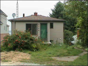 A small house with a satellite dish on top of it