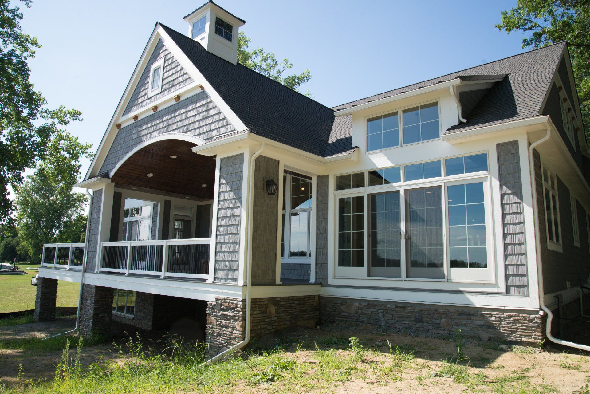 A large house with a large porch and lots of windows