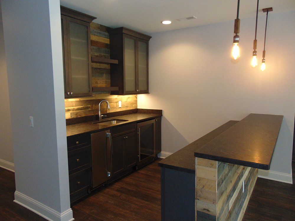 A kitchen with a sink and a bar in it