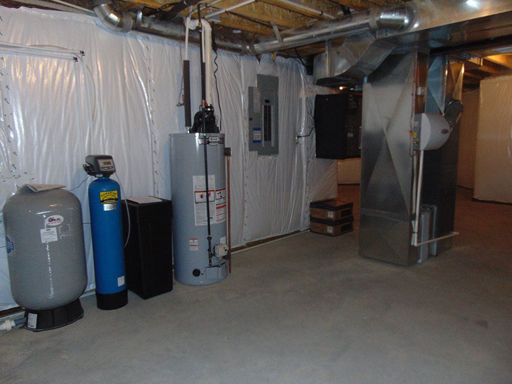 A basement with a water heater and a water filter