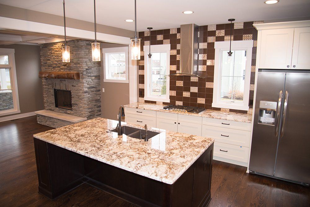 A kitchen with granite counter tops and stainless steel appliances.