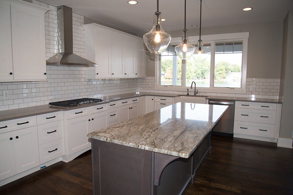 There is a large island in the middle of the kitchen.