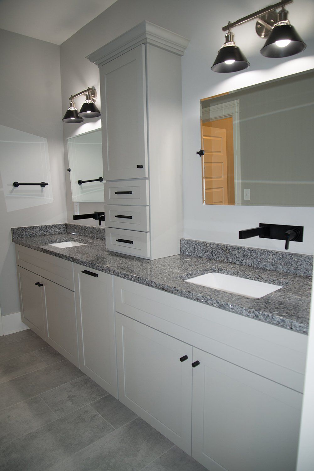 A bathroom with two sinks and two mirrors.