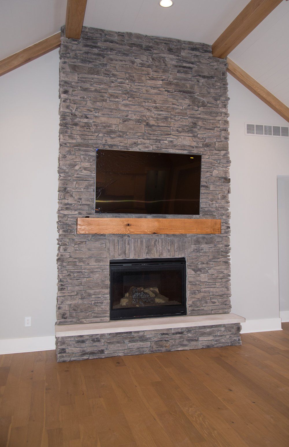 A fireplace with a flat screen tv mounted on it in a living room.