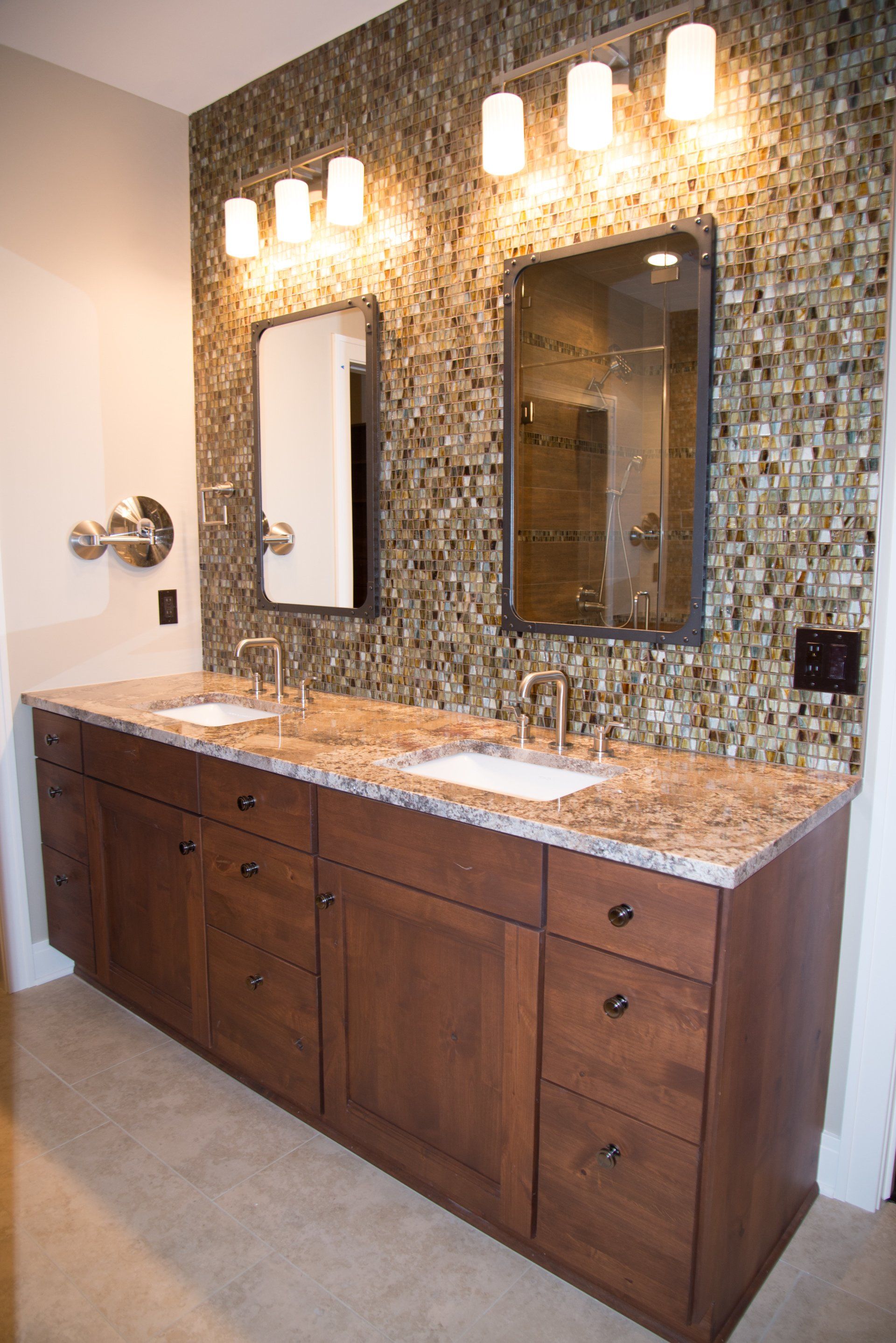 A bathroom with two sinks and two mirrors.