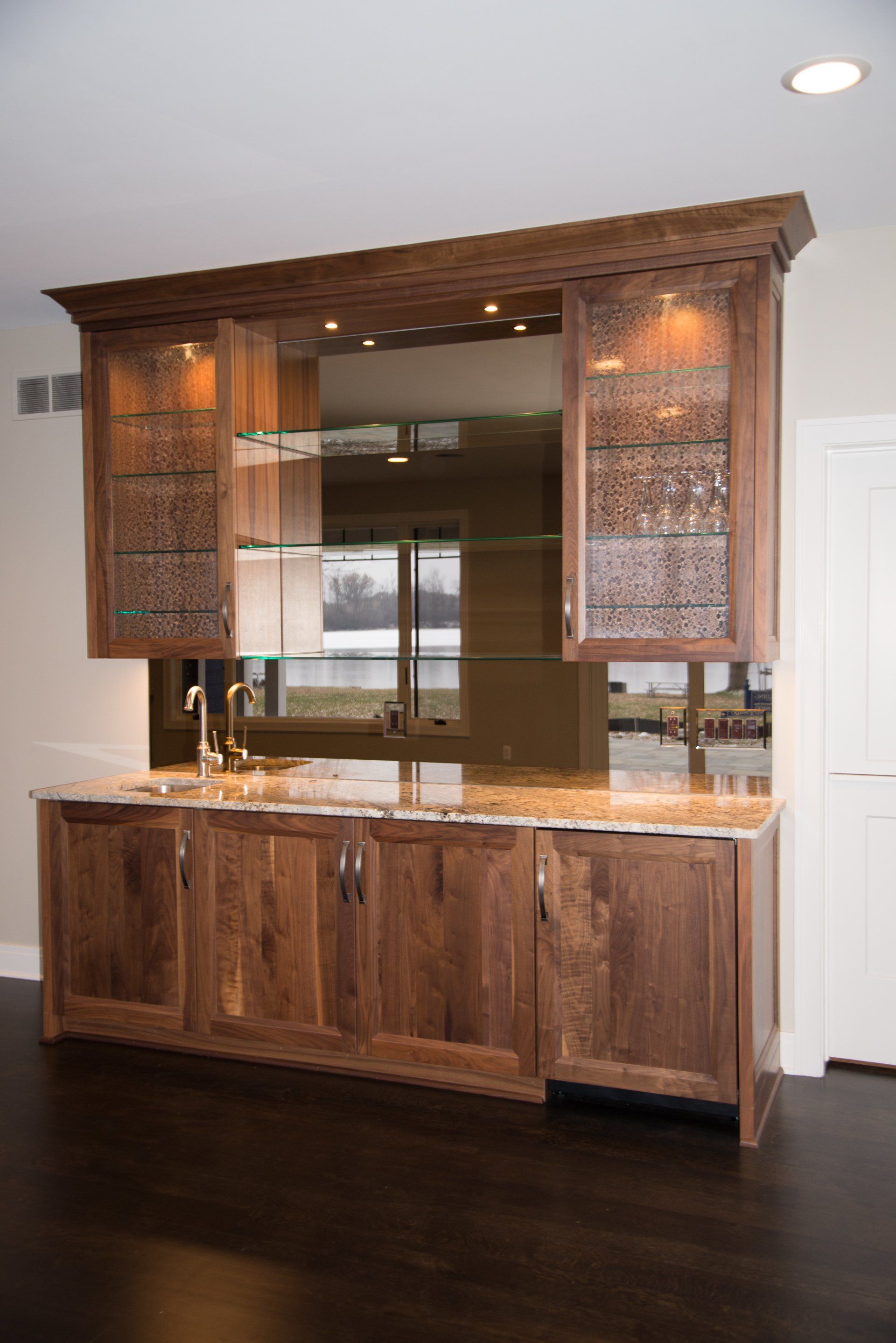 A kitchen with wooden cabinets and a sink.