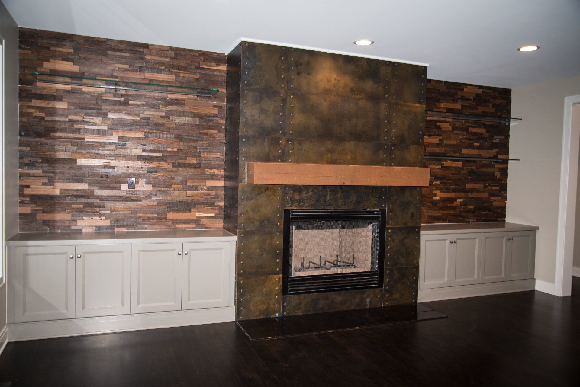 A living room with a fireplace and a brick wall