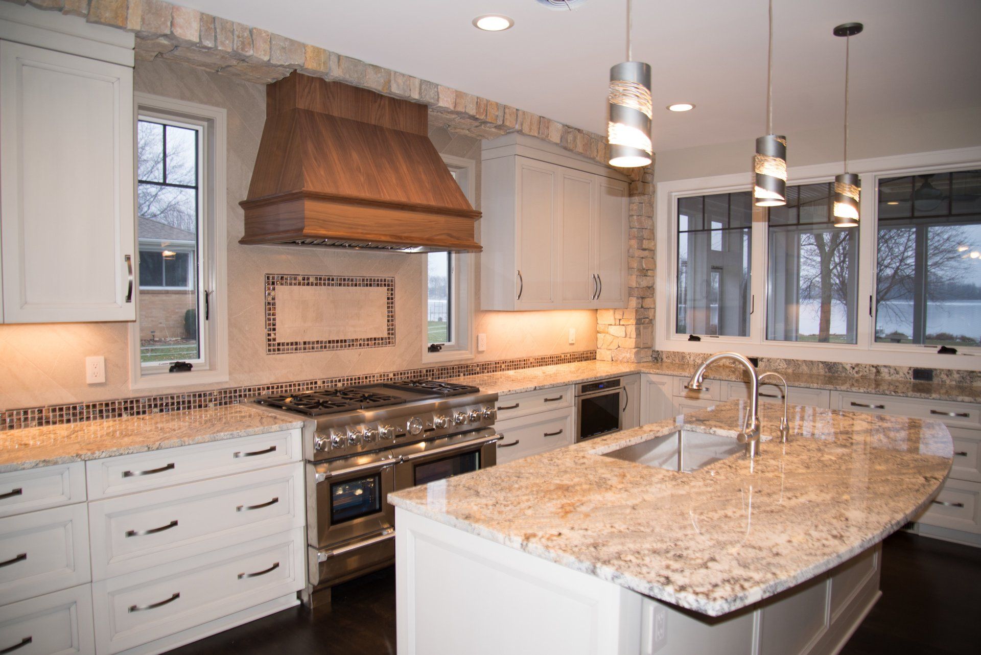 A kitchen with granite counter tops and stainless steel appliances