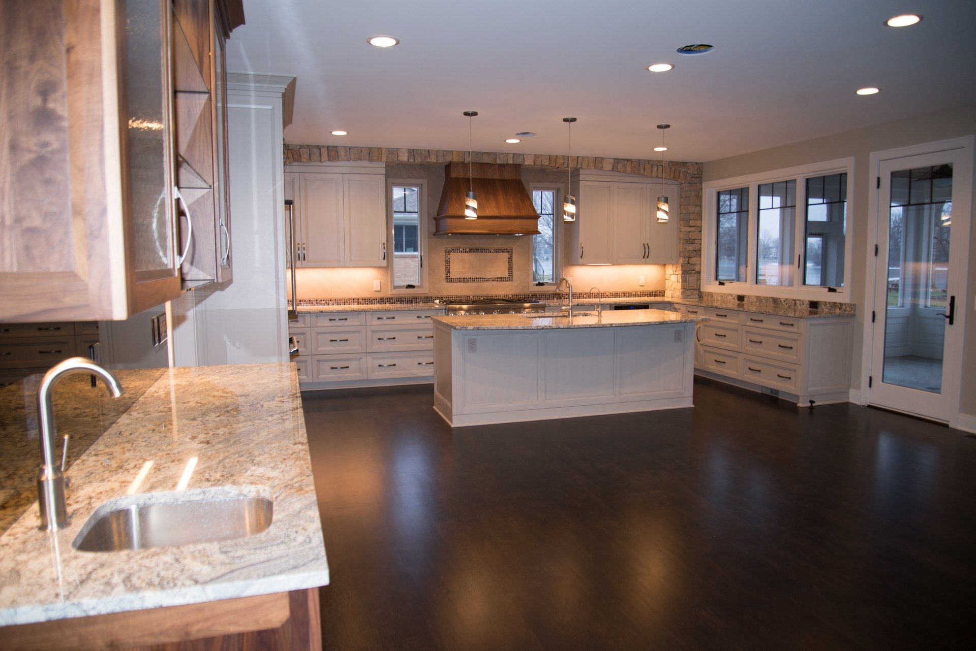 A kitchen with a large island and a sink