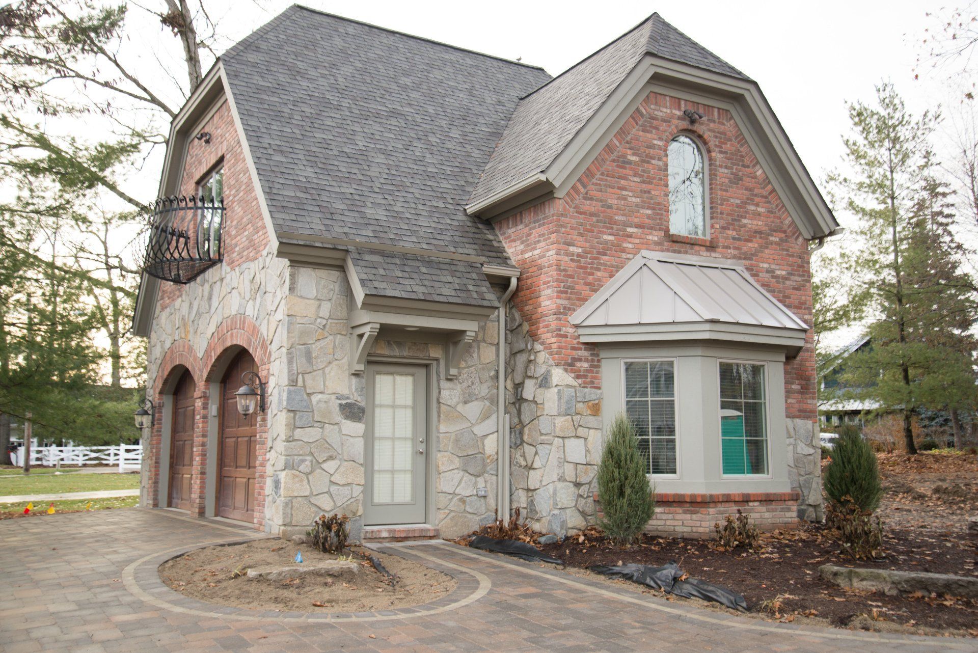 A brick and stone house with a gray roof
