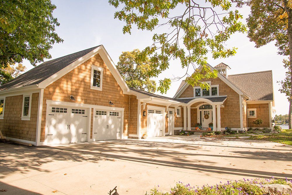 A large house with two garages and a porch