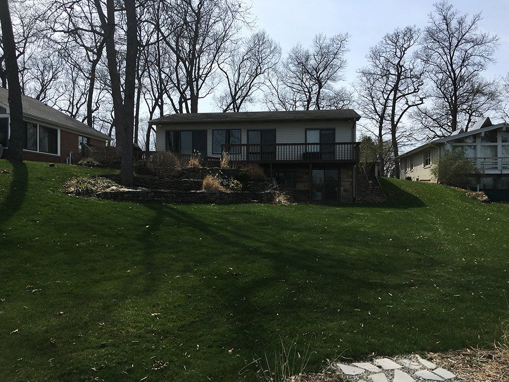 A house with a large lawn in front of it