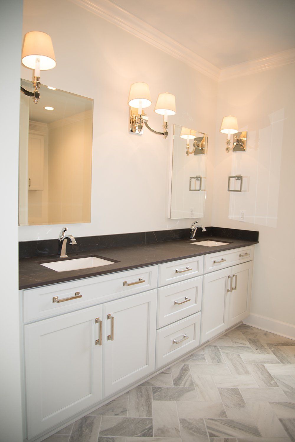 A bathroom with two sinks and a large mirror.