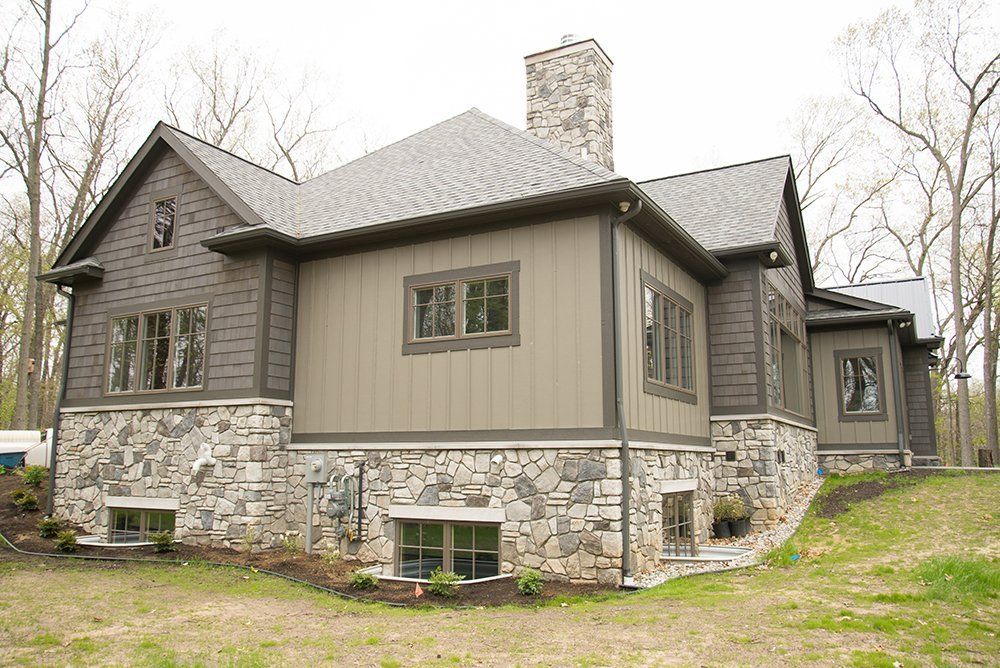 A large house with a lot of windows and a chimney