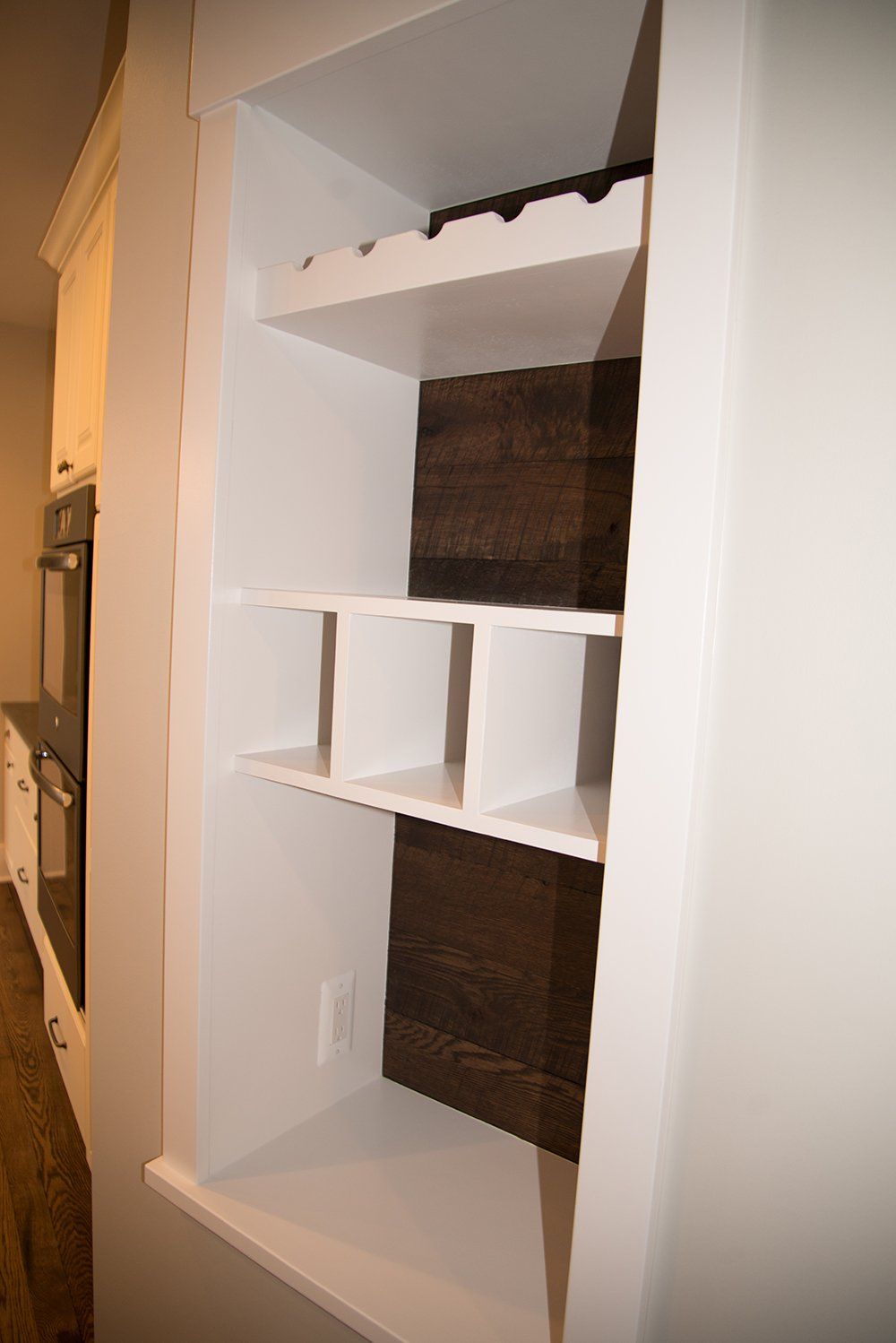 A wine rack is built into a wall in a kitchen.