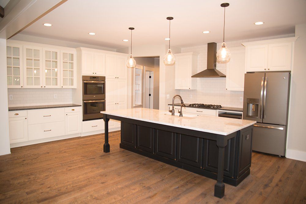 There is a large island in the middle of the kitchen.