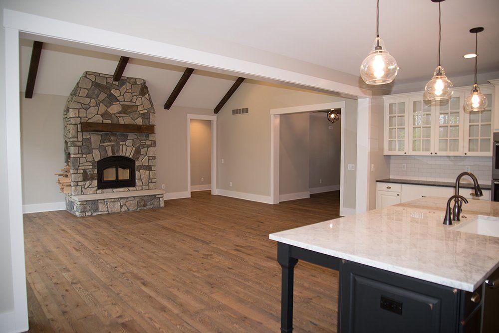 There is a fireplace in the middle of the living room.