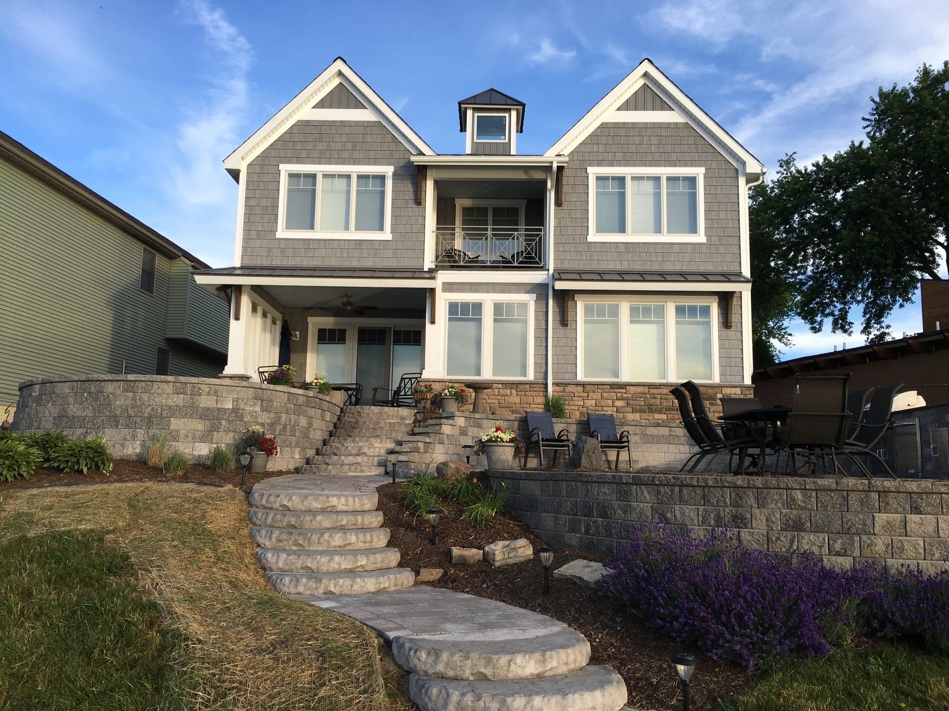 A large house with stairs leading up to it