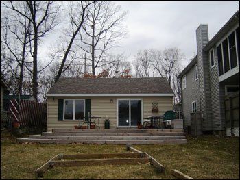 A small house with a sliding glass door and a deck