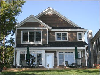 A large house with a lot of windows and umbrellas