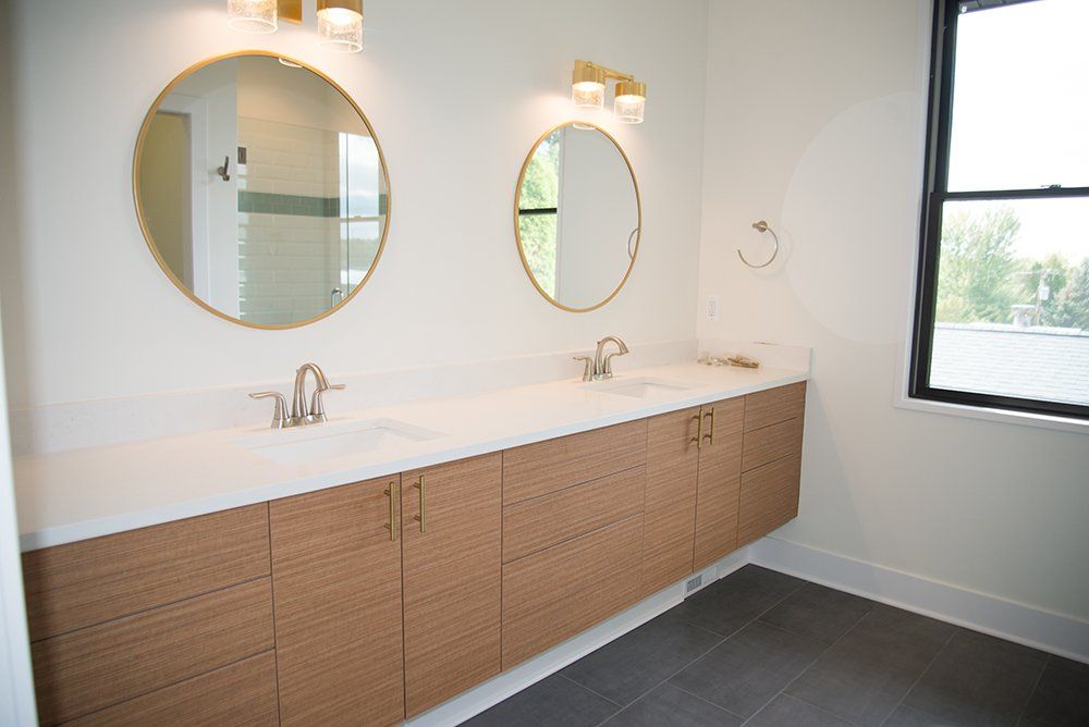 A bathroom with two sinks and two mirrors.