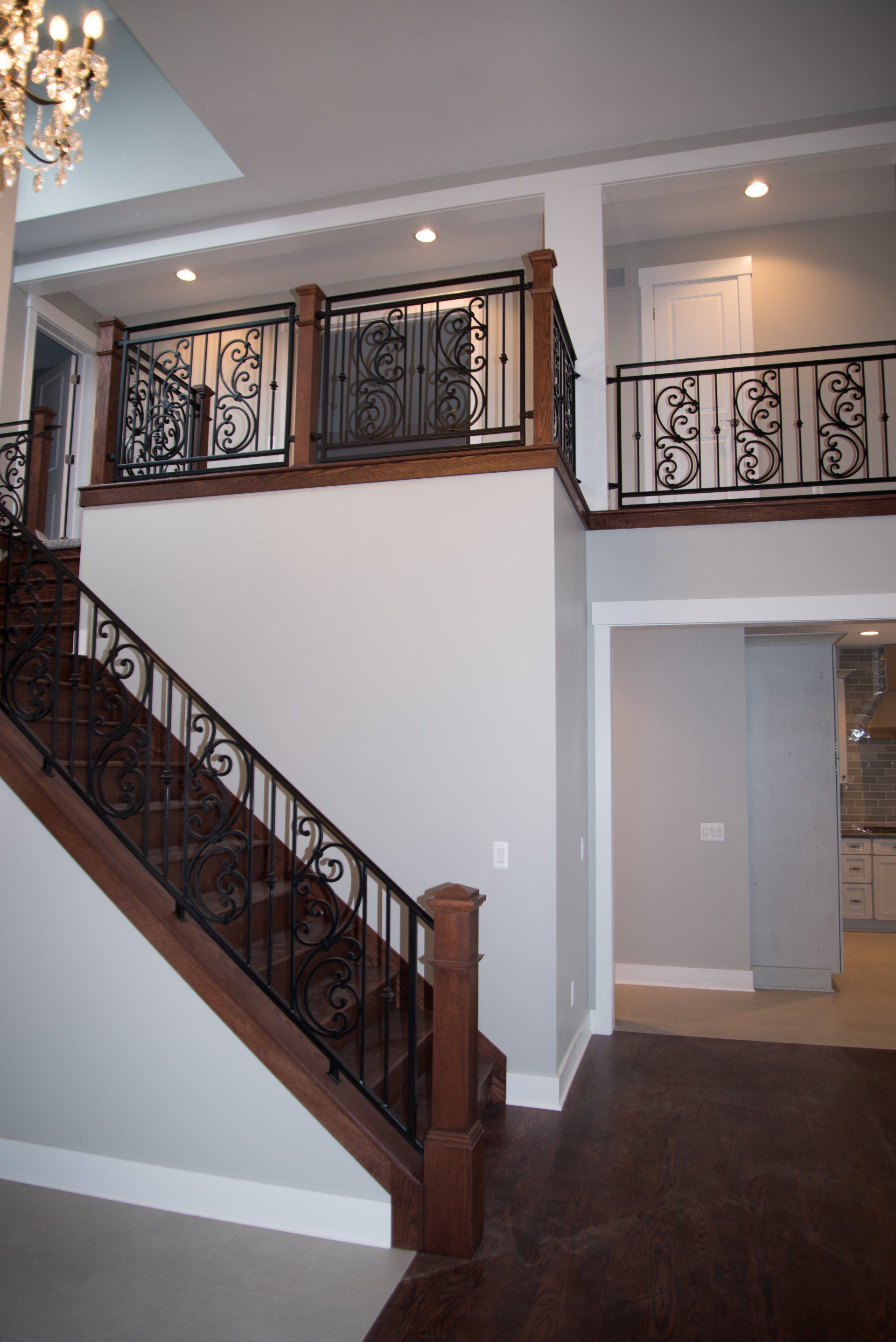 A staircase with a wrought iron railing in a house