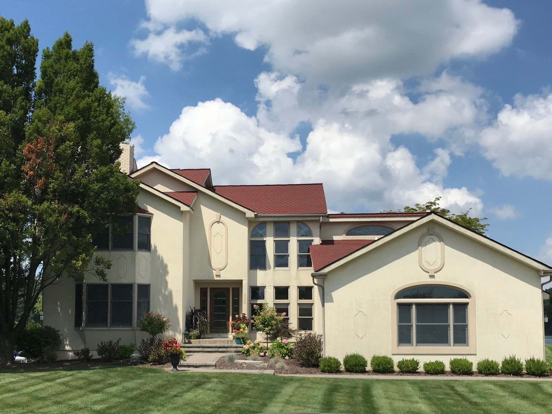 A large white house with a red roof