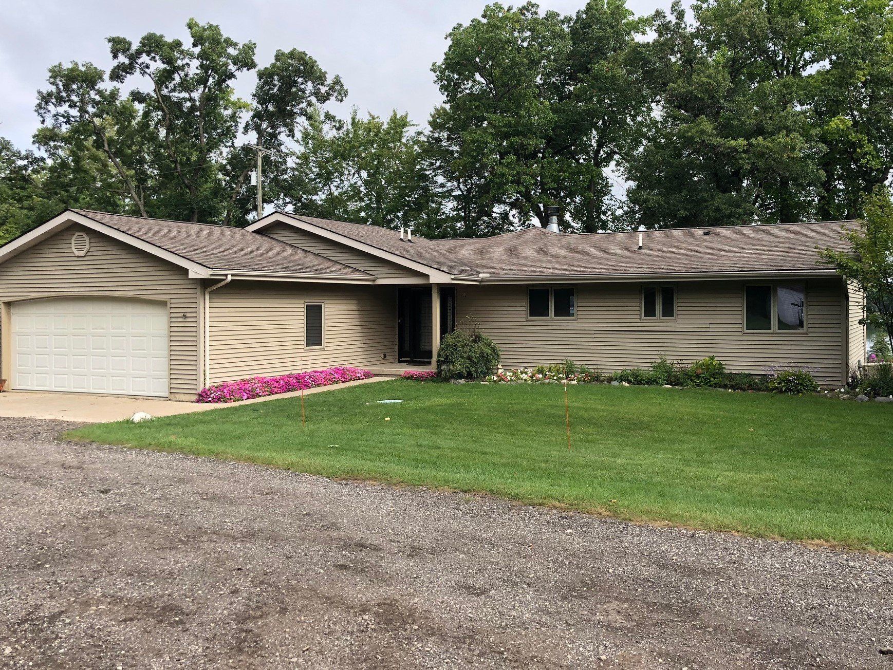 A house with a garage and a driveway in front of it