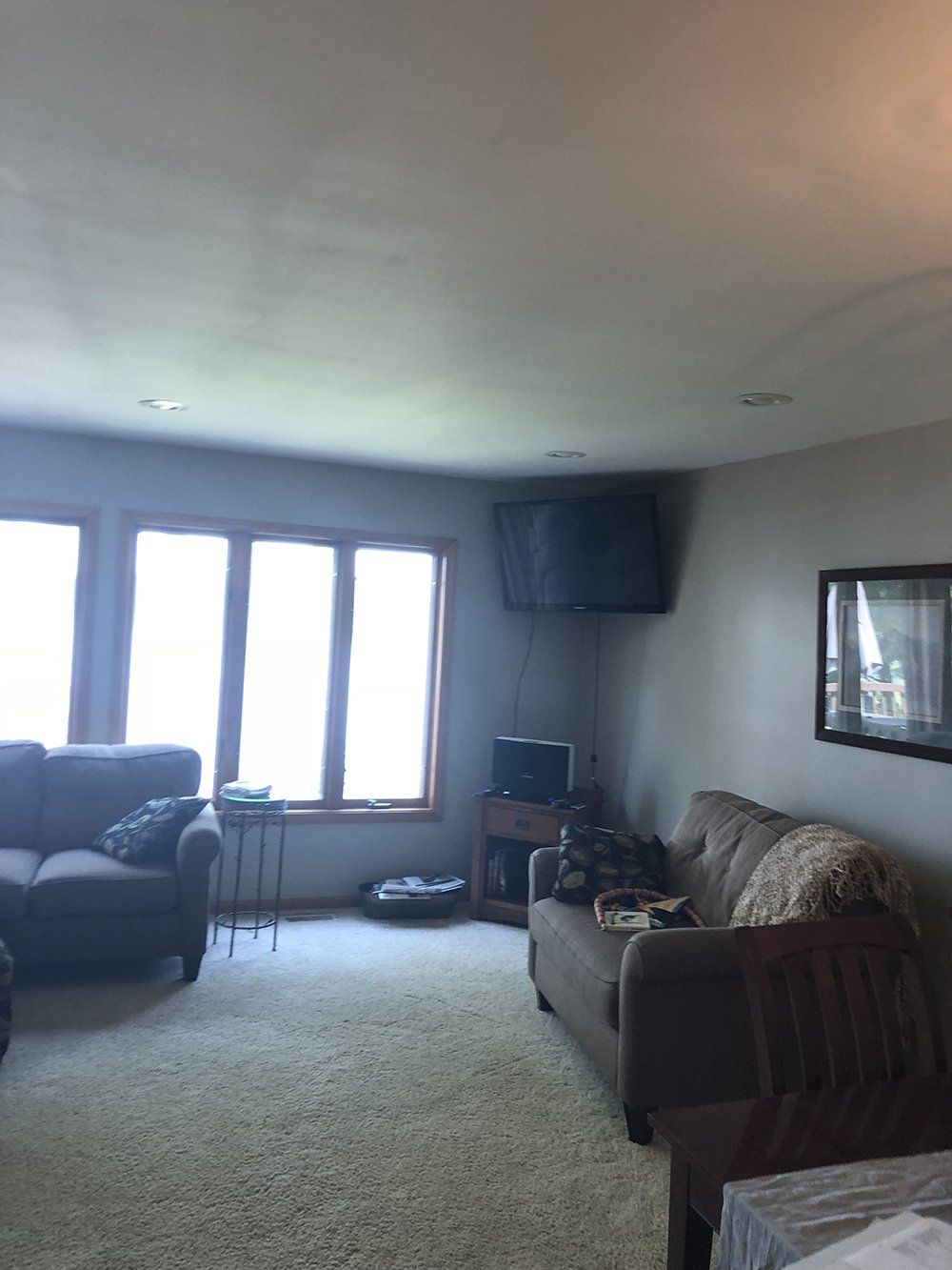 A living room with a couch a chair and a television