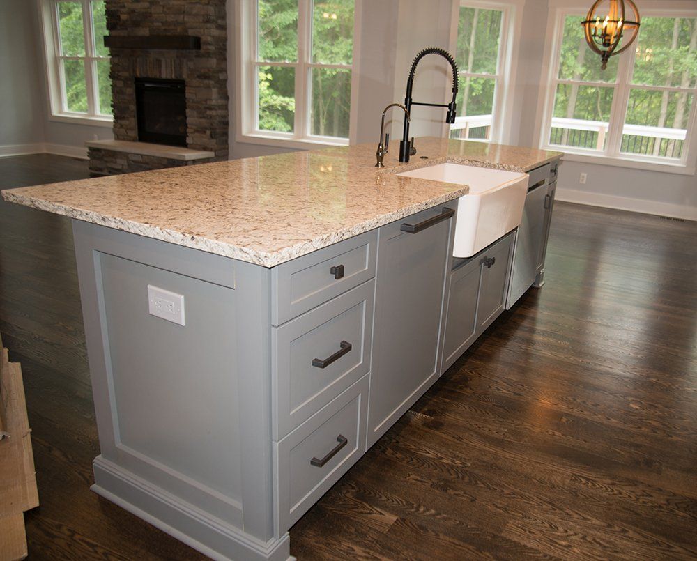 A kitchen with a large island and a sink