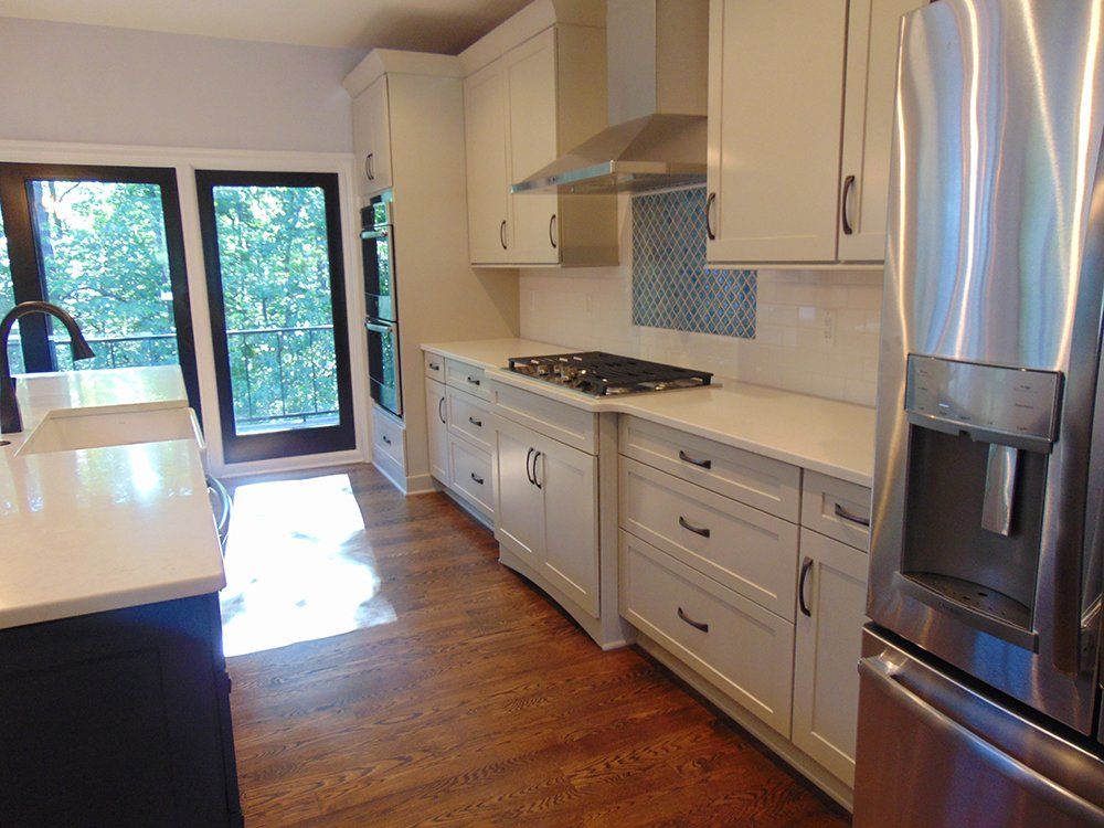 A kitchen with white cabinets and stainless steel appliances.