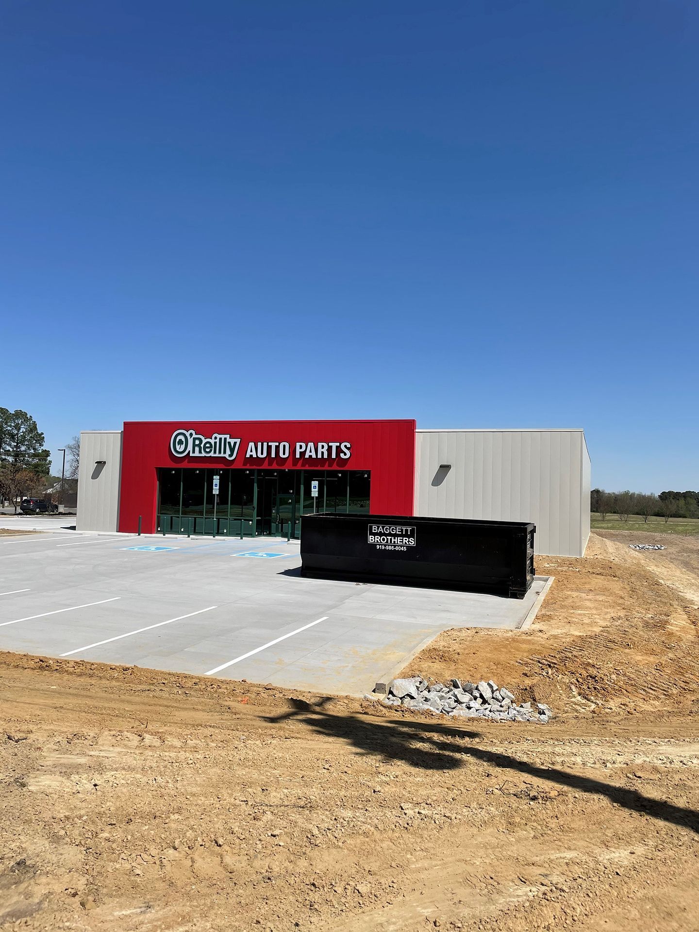 Roll Off Dumpster delivered outside of an auto parts store Raleigh, NC